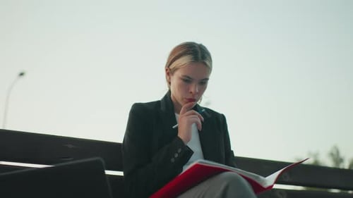 Young Woman Studying Outdoors in the Daytime