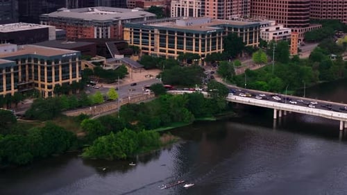 Bustling Cityscape of Downtown Austin From Above Showcasing Bridge Traffic and River Boats Amidst