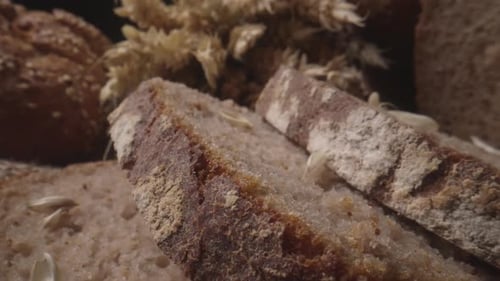 Rustic Bread and Ears of Wheat on the Old Vintage Table
