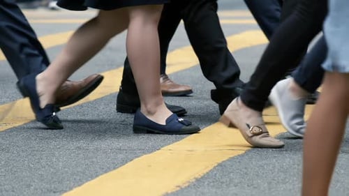 Close up of people walking on crowded street in slow motion.