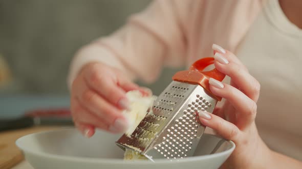 Close Up Hand View Of Cook Grating Egg Gently With Kitchen Grater ...