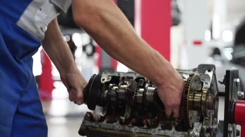 Mechanic Disassembles Engine Block Removes Crankshaft in Workshop Precision Work on Car Components