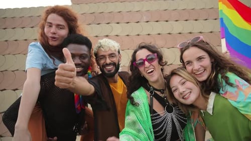 Group of Friends Laughing and Waving with Pride Flag