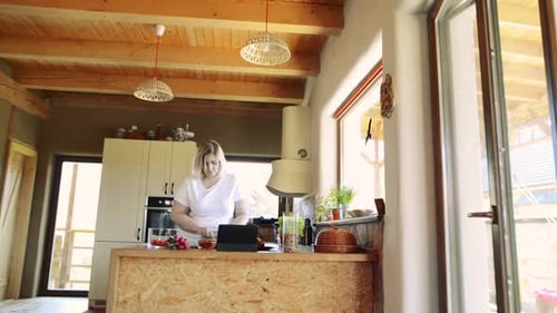 Woman Preparing Food in a Rustic Kitchen