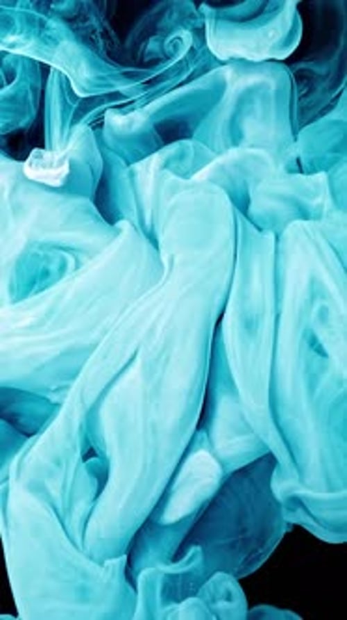 Turquoise Paint Swirling Abstractly on Black Background