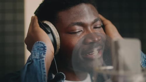 Singer Performs in Professional Music Studio During Recording Session