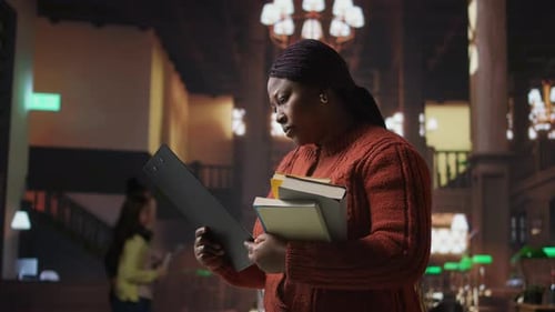 Female Educator Preparing Her Teaching Materials and Resources in the Library
