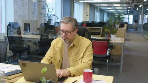 Focused Male Manager Working after Hours in Office