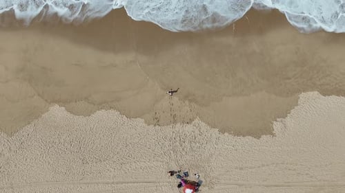 A Stunning Aerial View Featuring a Beautiful Beach with Gentle Waves and Soft Sand