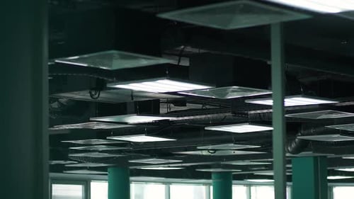 Handheld View of the Ventilation and Lighting System of Office Premises Walk Through the Office