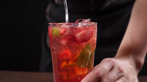 Refreshing Strawberry Drink being Stirred with Spoon