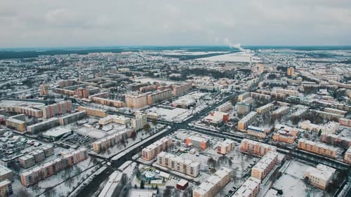 Aerial View of Blocks with Private Houses Among Snowcovered Fields and New Microdistrict on