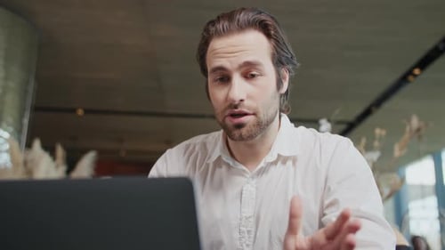 Close Up Attractive Young Business Man Talking in Video Conference Using Laptop Sitting Working