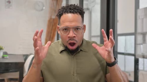 Man reacting in surprise indoors close up