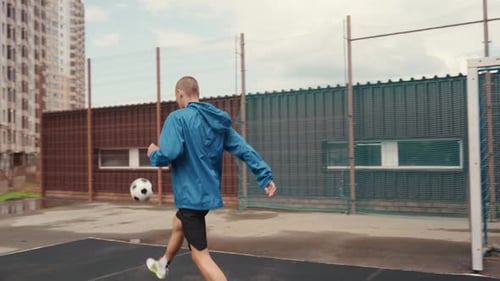 Man Juggling Soccer Ball on Outdoor Court