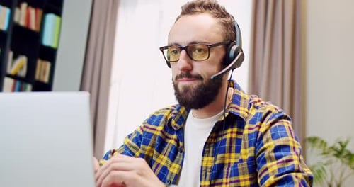Bearded Adult Using Laptop in Home Office