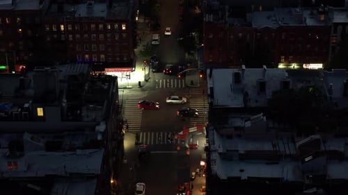 Aerial View of a Bustling New York City Intersection at Night Highlighting the Iconic Yellow Taxis