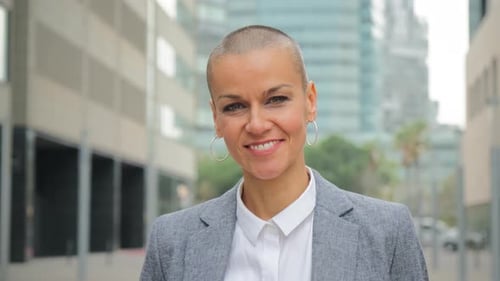 Smiling woman in business attire posing in city