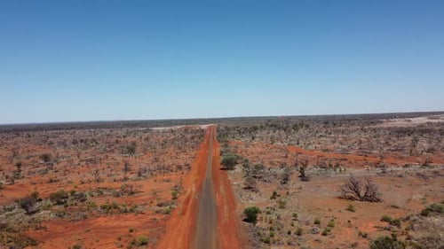 Drone ascending over country sealed and unsealed roads in the Australian Outback