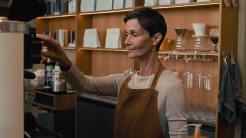 Woman Smiling in Cafe Making Coffee