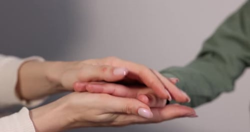 Hands Placed on Top of Each Other Indoors