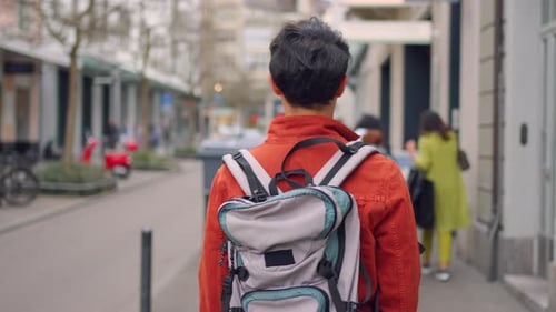 Asian attractive man backpacker walking around beautiful road in city.