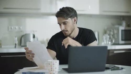 Empresario buscando papel en su lugar de trabajo. Joven empresario que trabaja con papeles