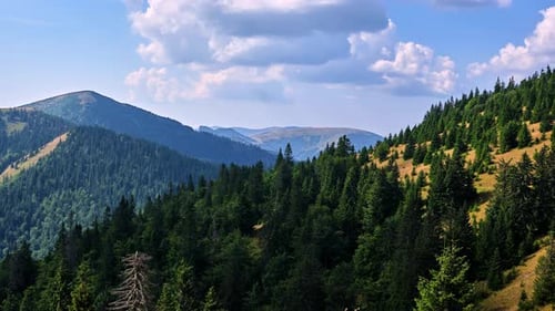 Timelapse of Clouds Passing Over a Forest Mountains