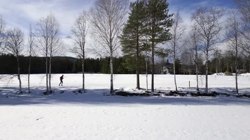 Runner Jogging Through a Snowy Winter Landscape