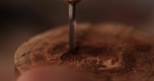 Drill Bit Drilling Into Wood Creating A Hole