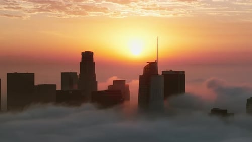 Downtown Los Angeles at Sunrise Features Fog and Clouds Creating a Serene View