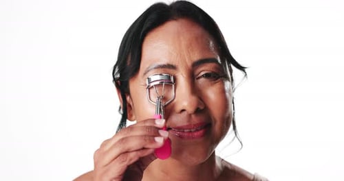 Face, woman and eyelash curler in studio for makeup, beauty aesthetic and mascara preparation