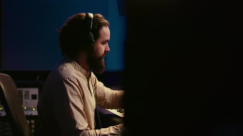 Audio Engineer Working at Sound Mixing Board