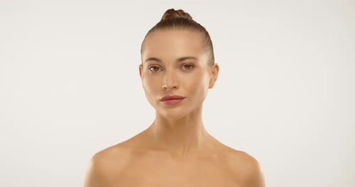 Beautiful Woman Posing Against a White Background