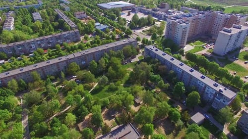 Long blocks of flats in the residential area. Green quarters with multi-storied buildings