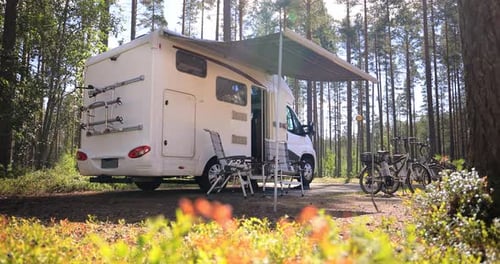 White Camper Parked Near Forest Trees