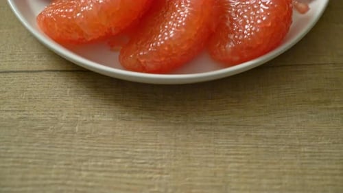 Fresh Pink Pomelo Slices on Plate, Close Up