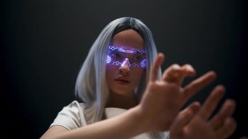Millennial woman swiping invisible images in digital transparent glasses futuristic interface