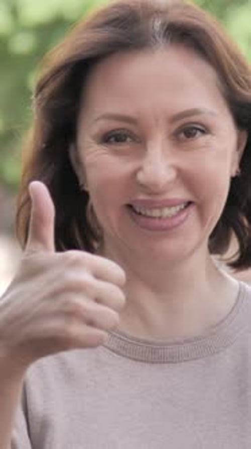 Thumbs Up by Old Woman Standing Outdoor by Road, Vertical Video