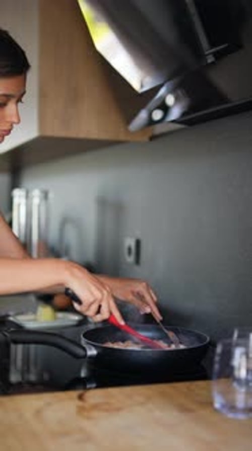 Young Woman Cooking Food in Kitchen Frying Pan