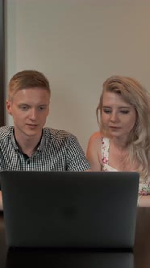 Couple Working Together at a Laptop Computer