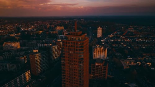 Aerial hyperlapse showing buildings, cars and city landscape.