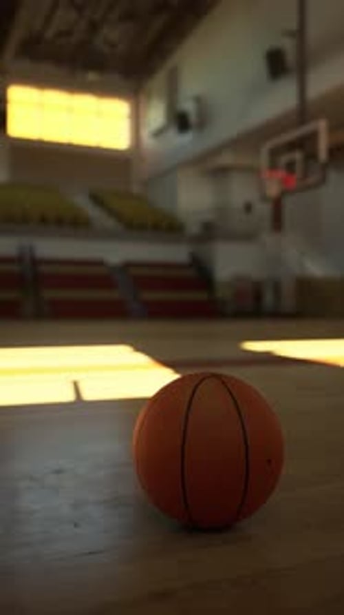 Basketball Resting on the Court Floor
