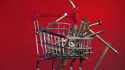 Closeup of Shopping Cart Trolley with Screws Construction Tools Online Store