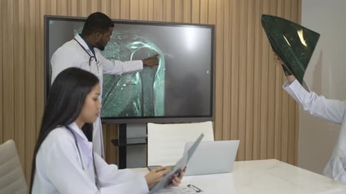 Medical Professionals Discussing X-Rays in Modern Office