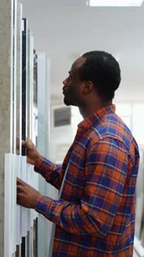 Young Black Guy Choosing Tiles at Building Market Vertical Video