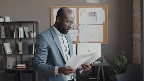 Male Worker Looking through Documents