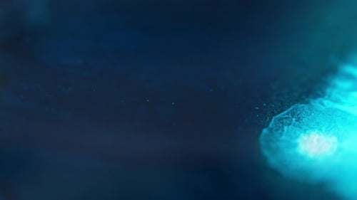 Abstract blue light glows softly in the dark, creating a mysterious and serene atmosphere