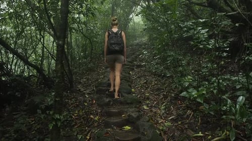 Woman hiking to volcano in Nicaragua tropical rain forest in exploring adventure