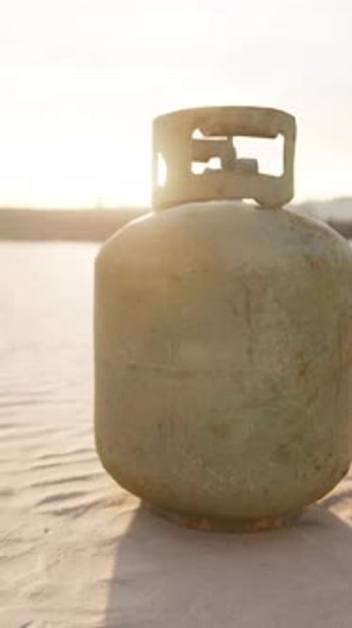 Old Rusted Metal Gas Tank on the Beach